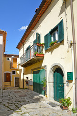 Fototapeta na wymiar Brindisi di Montagna, a narrow street among the old houses of a mountain village in the Basilicata region. 
