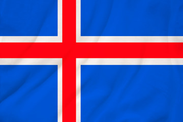 national flag of the country iceland on delicate silk with creases from the wind, concept of travel, immigration, politics, copy space, close-up