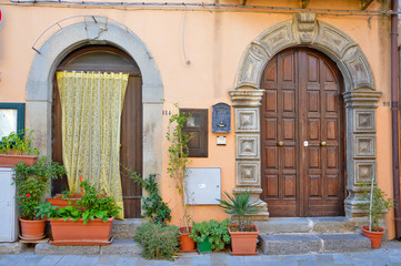 Fototapeta na wymiar Brindisi di Montagna, a narrow street among the old houses of a mountain village in the Basilicata region. 