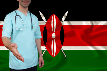 male doctor in uniform professional clothes with a stethoscope welcomes patients with his hand against the background of the national flag, the concept of the country's health and medical insurance