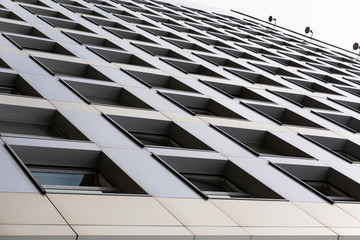 Diagonal view of building surface with lots of windows, ground view