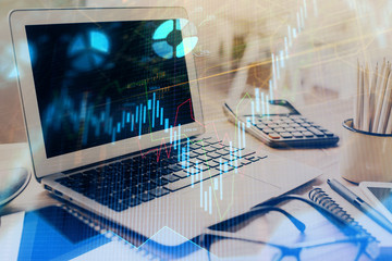 Stock market chart hologram drawn on personal computer background. Multi exposure. Concept of investment.