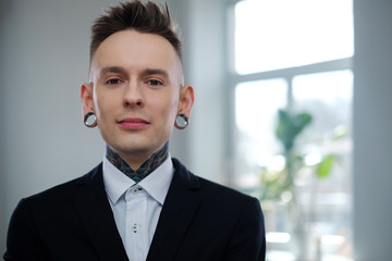 Portrait of alternative model with earplugs and tattoo