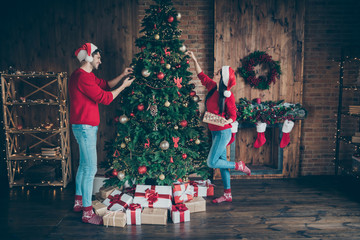 Full length profile side photo of two romantic people decorate christmas tree on x-mas holidays...