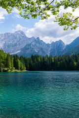 Fototapeta na wymiar Beautiful land scape of Lago di Fusine, the lake with background of Julian alps in Italy.