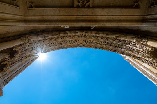 An arch of cathedral with sunray  with copy space on blue sky. Concept of architecture, histry.