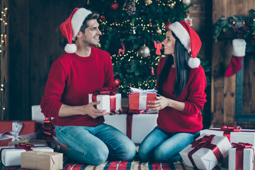 Full size profile side photo of two cheerful people give x-mas packages celebrate christmas time...