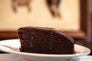 delicious chocolate cake with an Indian face in the back