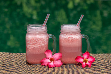 Grapefruit pink shake or smoothie on the table, close up. Breakfast in island Bali, Indonesia