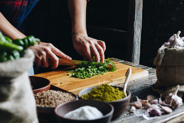 Woman hands chopping parsley