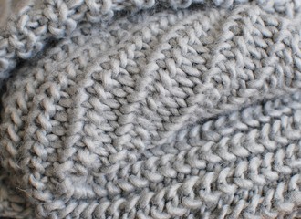 Gray knitted scarf closeup. Knitted texture for background.