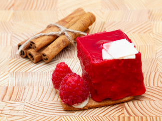 stylish new creative raspberry cake on a wooden background