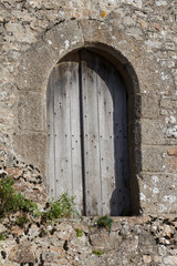 Window with wooden closed shutters in the ramparts of Mont Saint-Michel