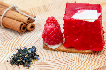 stylish new creative raspberry cake on a wooden background