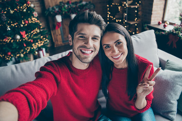 Fototapeta premium Top above angle photo of two people romantic guy and lady make v-signs selfie have christmas vacation x-mas holidays sit on divan in house with newyear decoration illlumination indoors