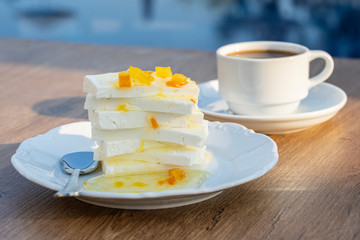 Curd cheese with lemon jam and cup coffee on table. Breakfast concept