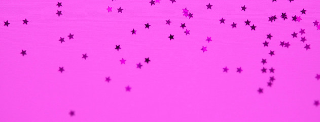 Golden stars glitter on pink background