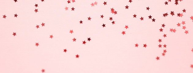 Golden stars glitter on pink background