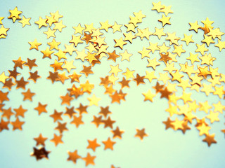 Golden stars glitter on blue background