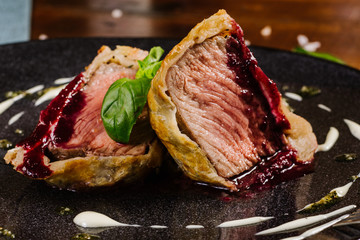 Tasty grilled pieces of meat with red sauce