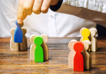 Groups of multicolored wooden people and businessman. The concept of market segmentation. Target...