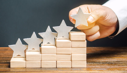 Critic puts the fifth star. The concept of the rating of hotels and restaurants. The evaluation of visitors. Quality level, good service. Best customer rating. Feedback. Satisfaction