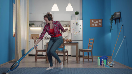 Woman is cleaning, dancing while her husband and son come.