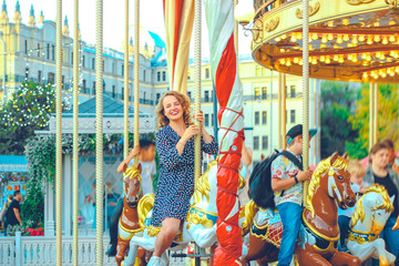 Obraz na płótnie Canvas Young pretty woman closeup in different poses on the carousel background near Red square in Moscow