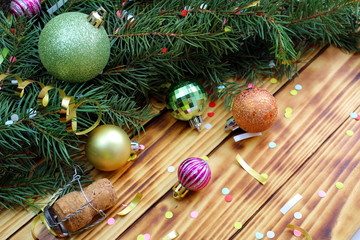 on the table is a fir branch with toys and confetti