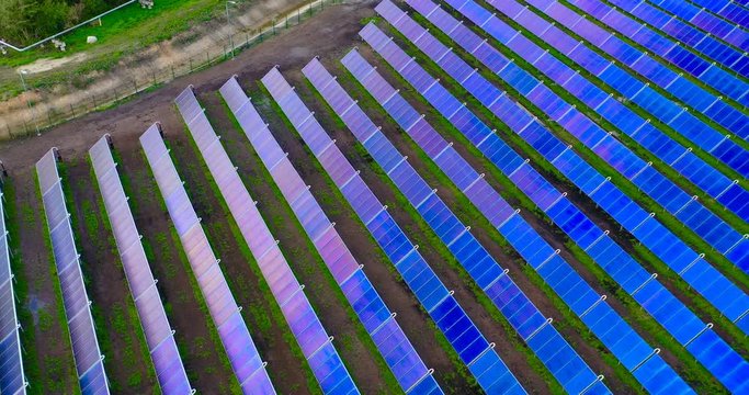 Ariel view , Shot from a drone on a farm field there are a lot of solar panels that produce environmental energy. 