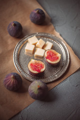 Figs and cheese on a metal plate 
