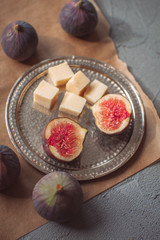 Figs and cheese on a metal plate 
