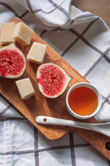 Figs and cheese on a wooden table