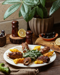Plate of lula kebab with mashed potato kebab