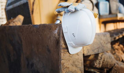 White hard hat, gloves on construction site