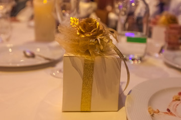 Gift package finely decorated with gold-colored ribbon