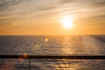 Dreamy sunset and wake left on the sea by a cruise ship