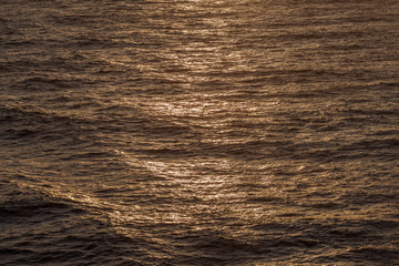 Sun rays reflections on the waves of the Mediterranean sea at sunset