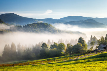 Fog in the valleys of the mountain landscape in autumn morning. The Orava region near the village...