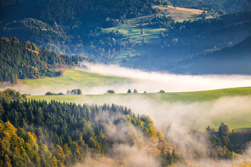Fog in the valleys of the mountain landscape in autumn morning. The Orava region near the village...