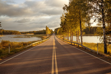 Fototapeta premium Autumn highway along the bay and forest