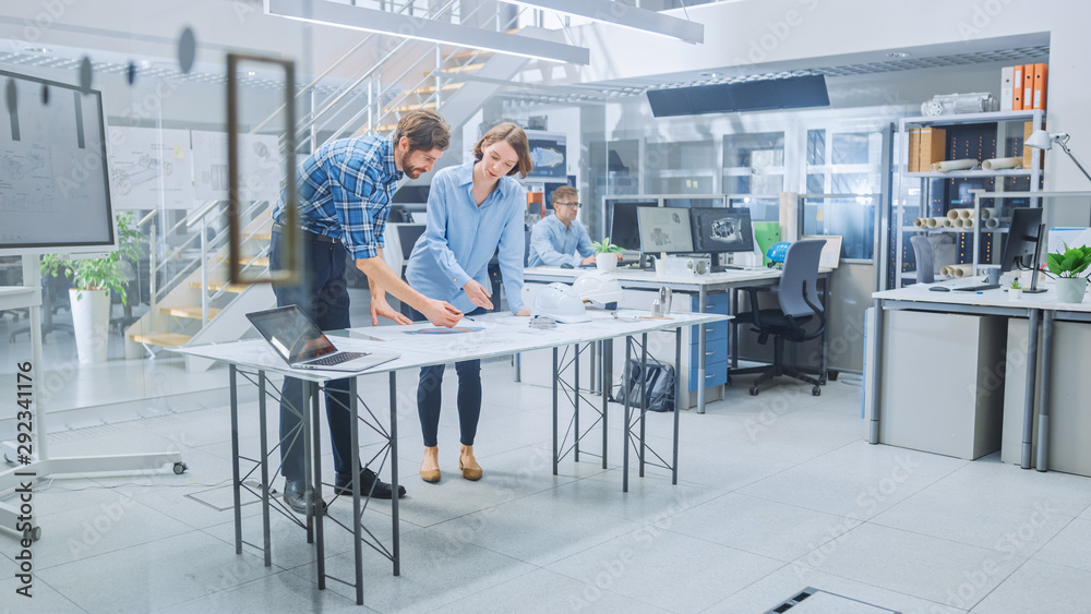 Poster in the busy engineering facility: diverse group of engineers, technicians, working on design for ind