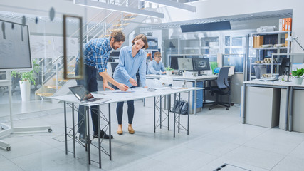 In the Busy Engineering Facility: Diverse Group of Engineers, Technicians, Working on Design for...
