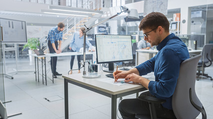 In the Busy Engineering Facility: Diverse Group of Engineers, Technicians, Working on Design for Industrial Engine Prototype. Specialists Talk During Meetings, Work with Drawings, Use Computers