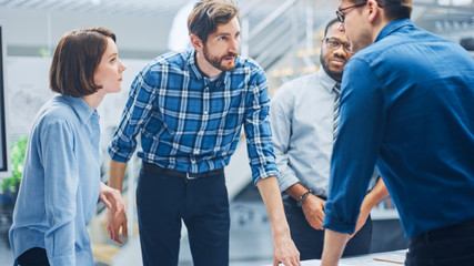 In the Industrial Engineering Facility: Diverse Group of Engineers and Technicians on a Meeting...