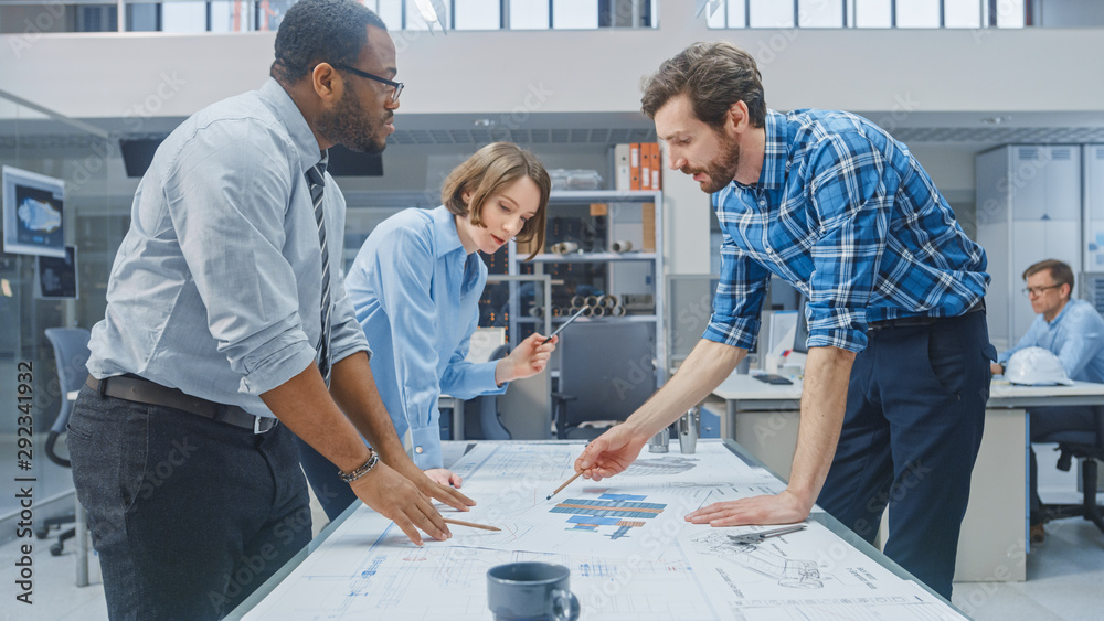 Poster in the industrial engineering facility: female designer works with industrial engineer and master te