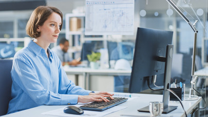 In the Industrial Engineering Facility: Portrait of the Smart and Beautiful Female Engineer Working...