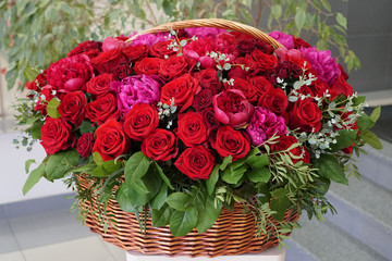 huge bouquet of roses and peonies in a basket
