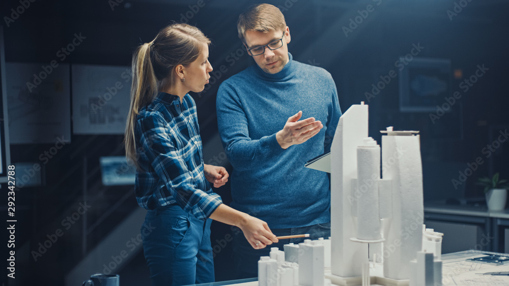 Fototapete in the creative architectural bureau two professional engineers work on a model of a city district. 