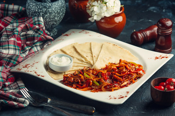 Chicken saute with colourful bell peppers, onion, and served with flatbreads